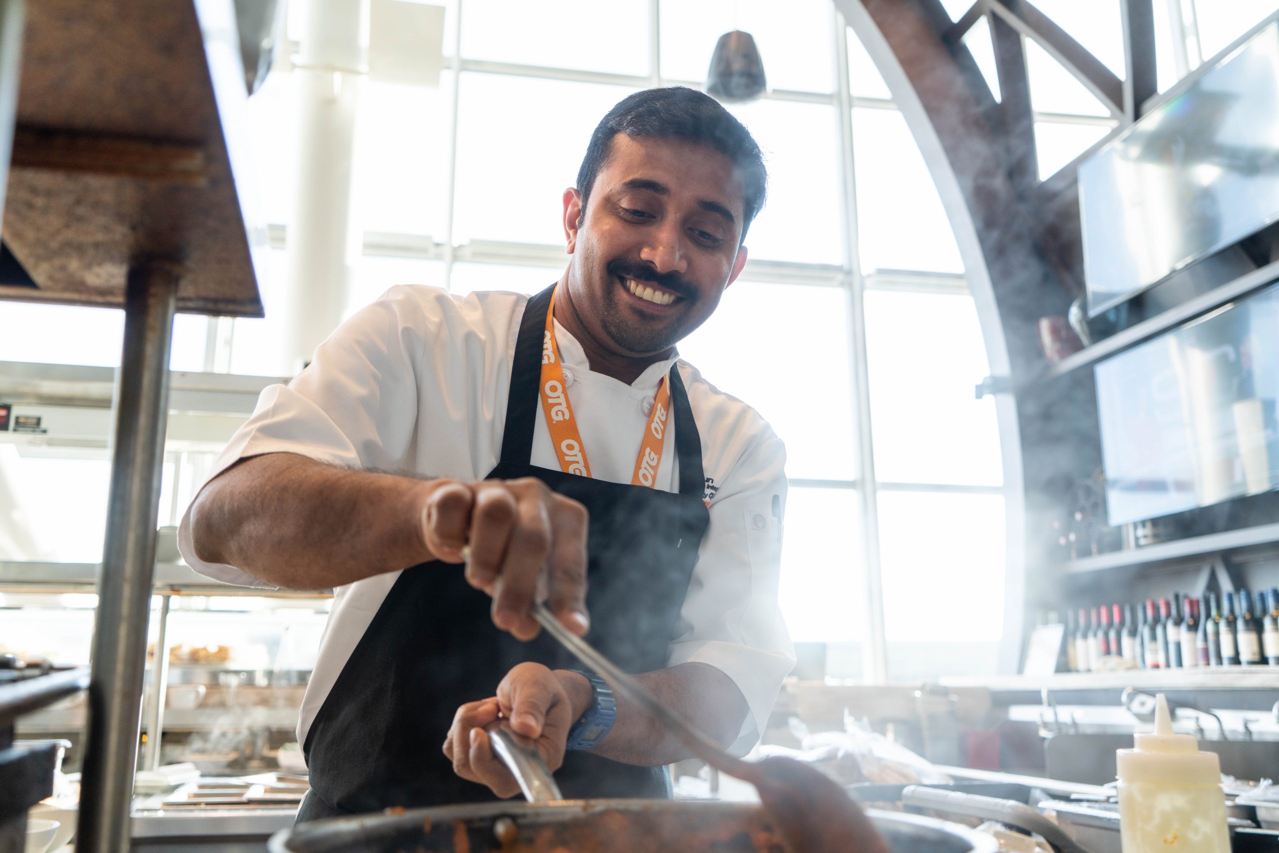 Hourly Roles at OTG Section Cook in kitchen preparing food